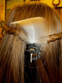 Close-up of feather on woman hair