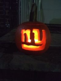 Close-up of illuminated pumpkin on wall during halloween