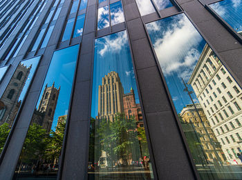 Low angle view of buildings seen through glass window