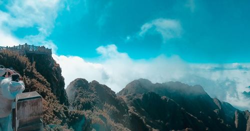 Low angle view of mountains against cloudy sky