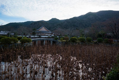 Scenic view of mountains and houses against sky