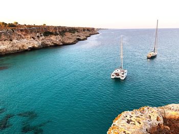 High angle view of rocks by sea against sky