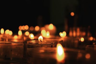 Close-up of illuminated candles in temple