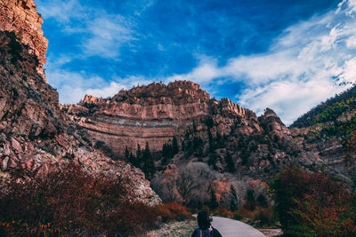 Rock formations on landscape against cloudy sky