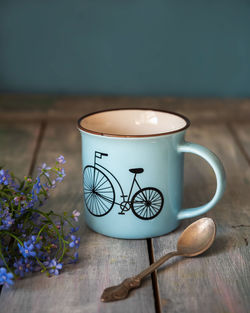 Coffee in a blue mug and a bouquet of forget-me-nots on a morning mood, rustic style