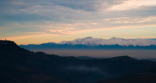 Scenic view of mountains against sky during sunset