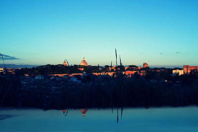 View of buildings against blue sky at sunset