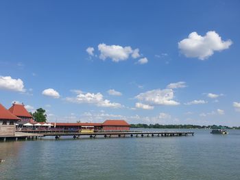 Building by sea against sky