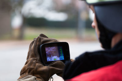 Rear view of man using mobile phone