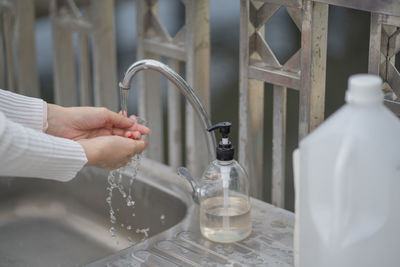 Person holding glass of water