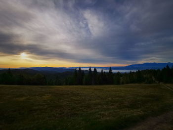 Scenic view of field against sky during sunset