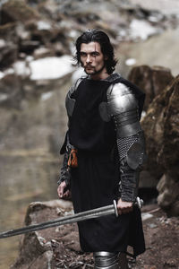 Close-up of young man wearing costume while standing on rock