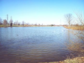 Scenic shot of calm lake against clear sky