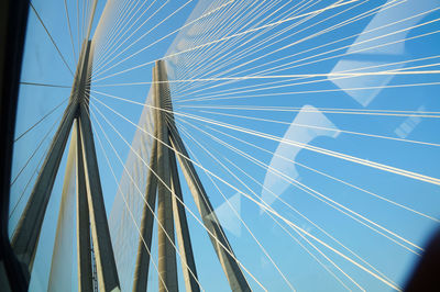 Low angle view of cables against blue sky