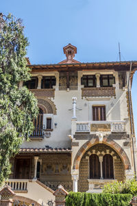 Low angle view of buildings against clear blue sky