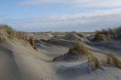 Scenic view of desert against sky during winter