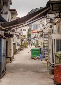 Empty road amidst buildings in town