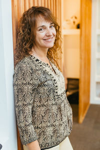 Portrait of young woman standing at home