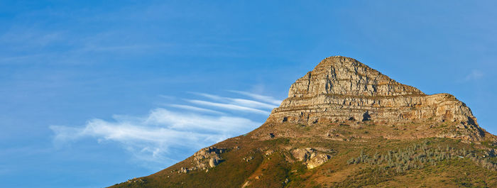 Low angle view of rock formations against sky