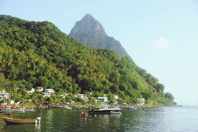 Scenic view of river and mountains against sky