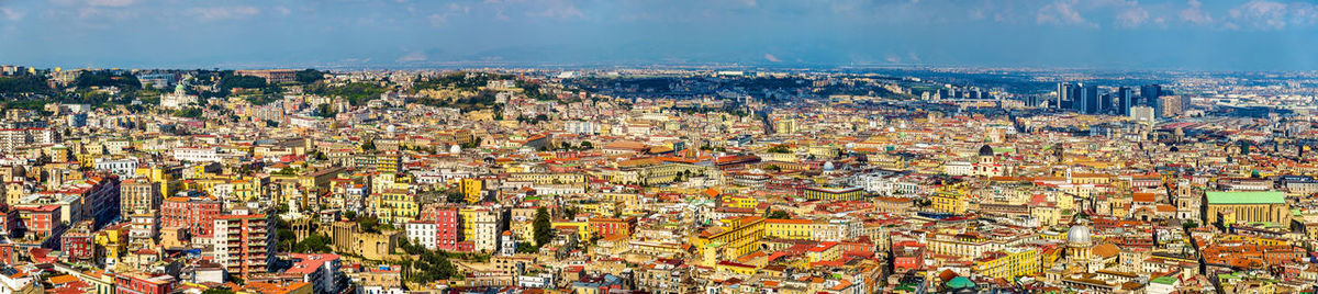 High angle view of cityscape against cloudy sky