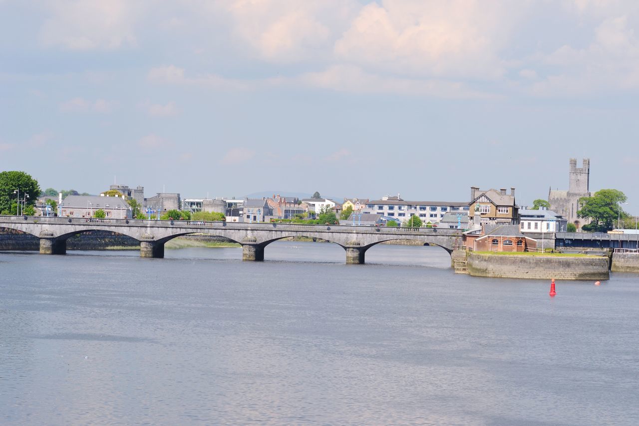 architecture, built structure, connection, bridge - man made structure, building exterior, water, sky, river, bridge, waterfront, transportation, city, cloud - sky, arch bridge, engineering, cloud, travel destinations, day, arch, travel