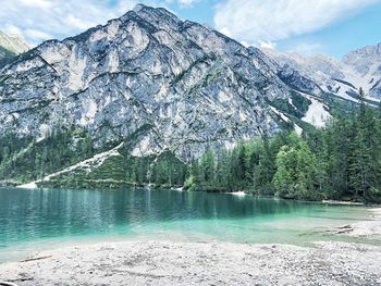 Amazing frontal view of dolomites and torquoise water of braies lake , italy , fairytales .