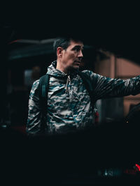 Man looking away seen through car window