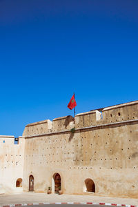 View of fort with flag against sky