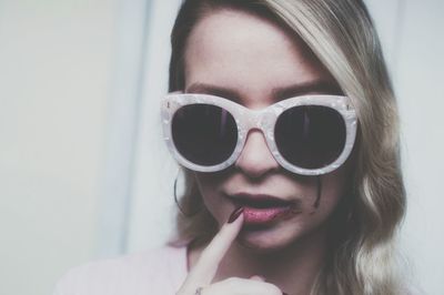 Close-up portrait of woman wearing sunglasses  cryin blood