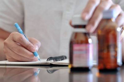 Close-up of man using mobile phone on table