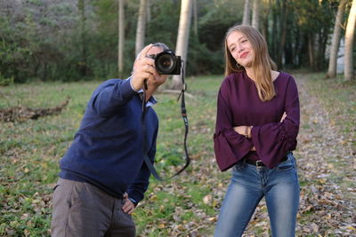 Man photographing with girl on ground