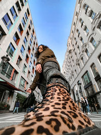 Low angle view of man against buildings in city