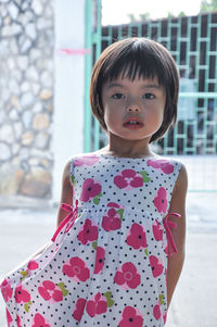 Portrait of cute girl standing on field 