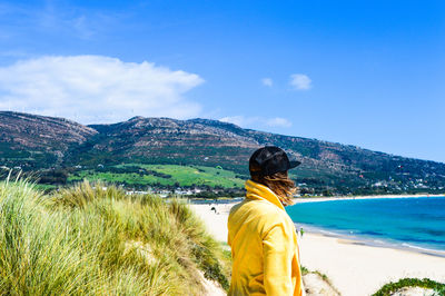 Rear view of man standing on mountain