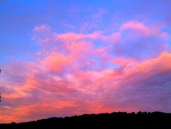 Low angle view of silhouette trees against sky at sunset