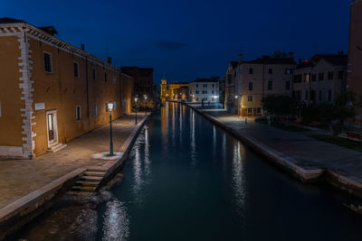 Canal amidst buildings in city