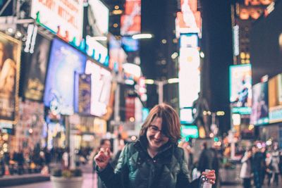 Portrait of a smiling young woman on the street