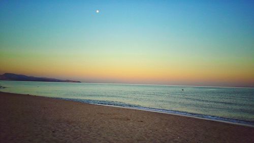 View of calm beach at sunset