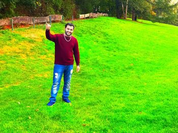 Full length portrait of man standing on field