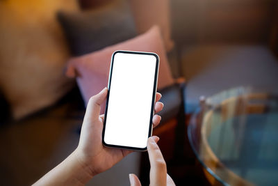 Midsection of man using mobile phone
