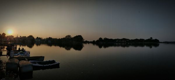 Scenic view of lake against clear sky during sunset