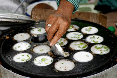 Midsection of man preparing food