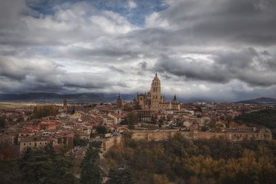 Cityscape against cloudy sky