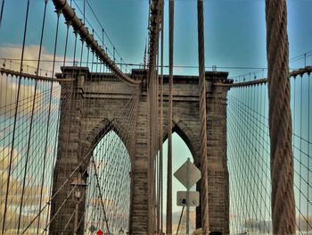 Low angle view of suspension bridge against sky
