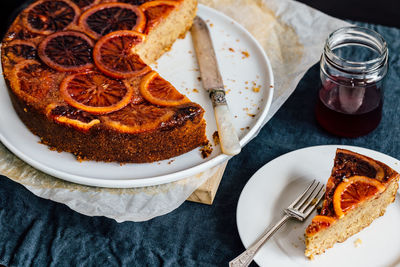 High angle view of dessert in plate on table, blood orange syrup cake