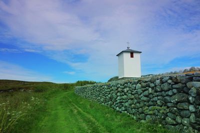 Lighthouse against cloudy sky