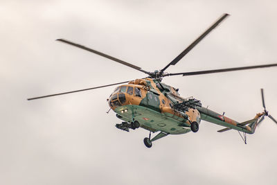 Low angle view of helicopter against sky