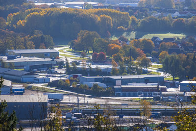 High angle view of trees and buildings in city