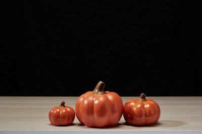 Close-up of tomatoes on table against black background